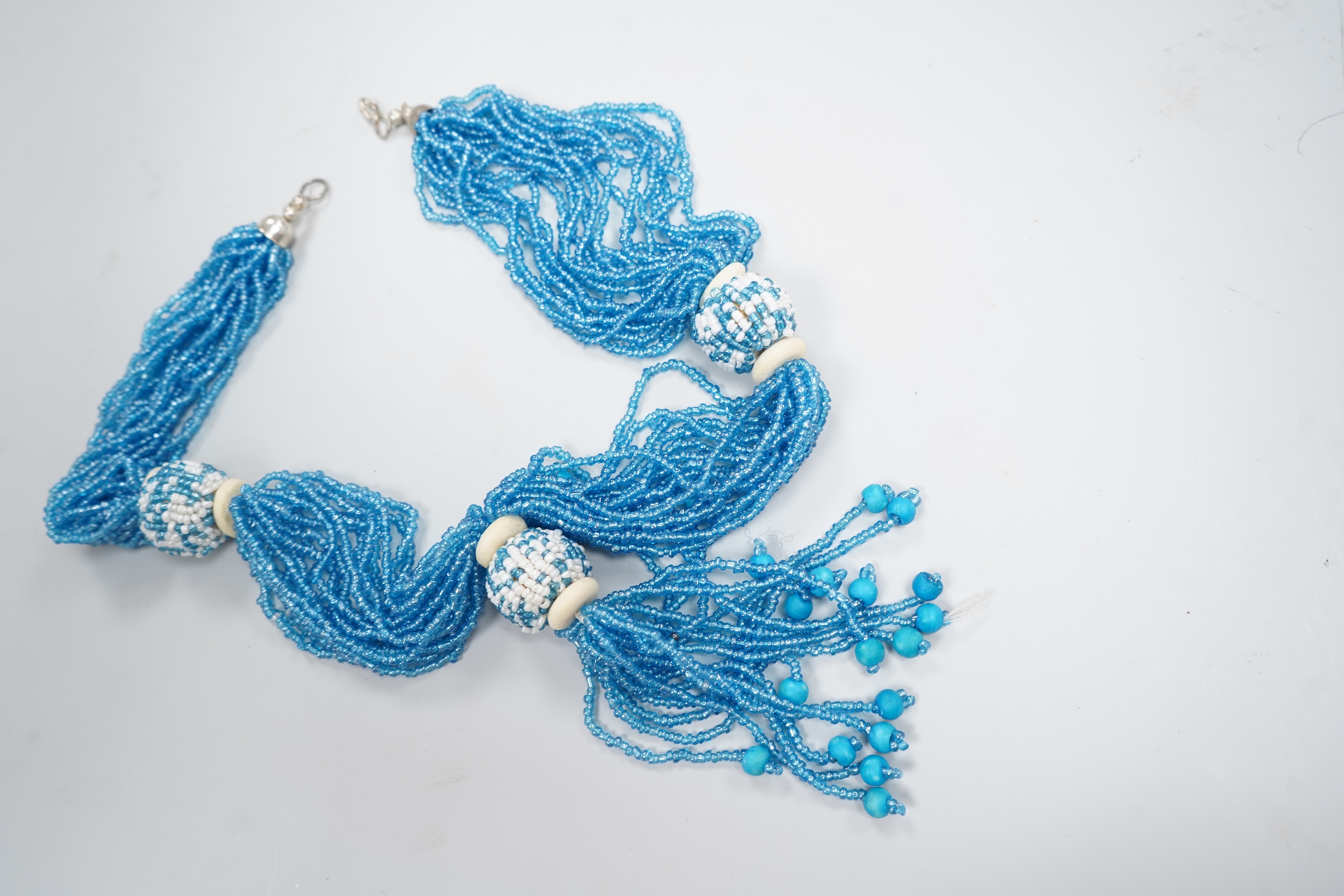 A group of beadwork floral appliqués, necklaces and an evening bag